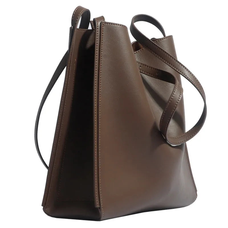 Brown genuine leather women's retro bucket bag with double shoulder straps showing interior organisation compartments