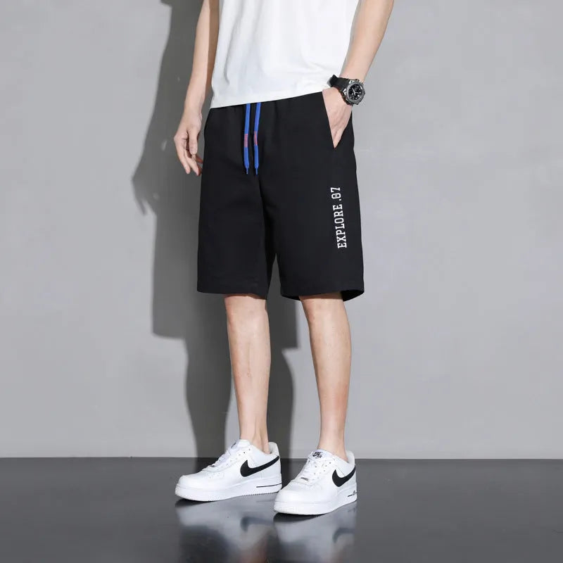Boy wearing black cotton plus-size shorts with a mid-waist and casual overalls style.
