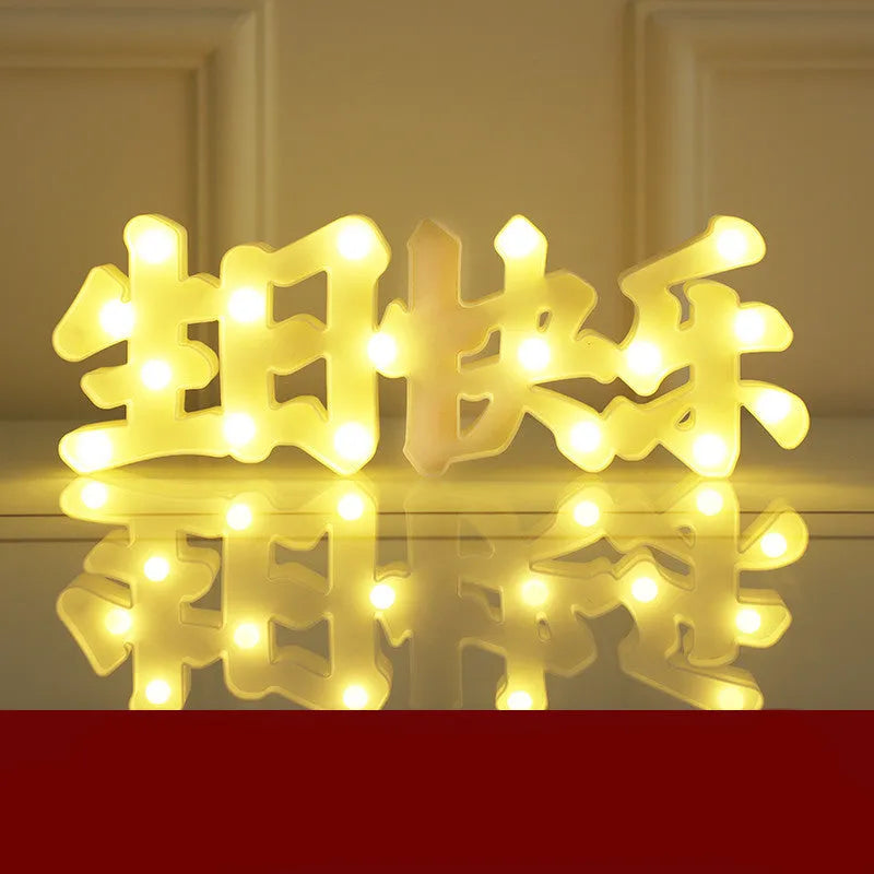 Plastic LED letter light decoration spelling a message, 22cm in height.