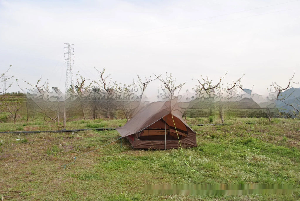 Brown A-line tent for 2-3 people with PU4000 waterproof fabric, 210x150x110cm, set in a grassy campsite.