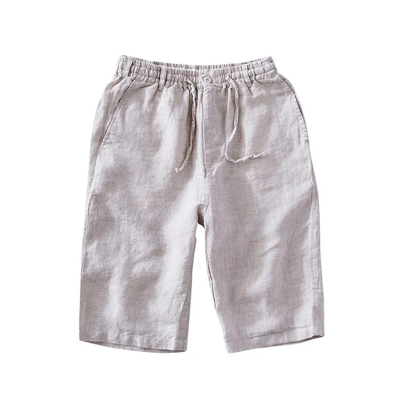 Men's loose-fitting linen capri trousers in a straight-leg style on a neutral background.