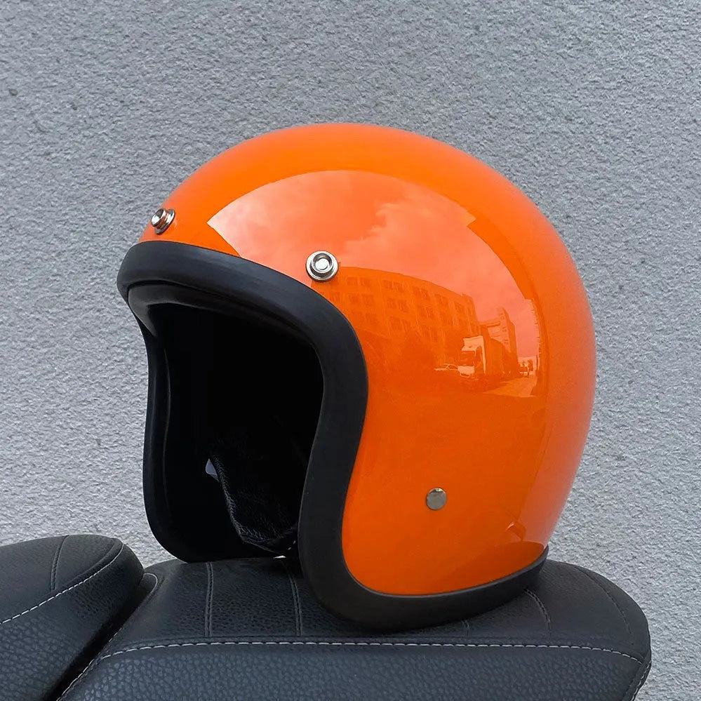 A retro-style grey half helmet for motorcycle riding, shown on a stand.