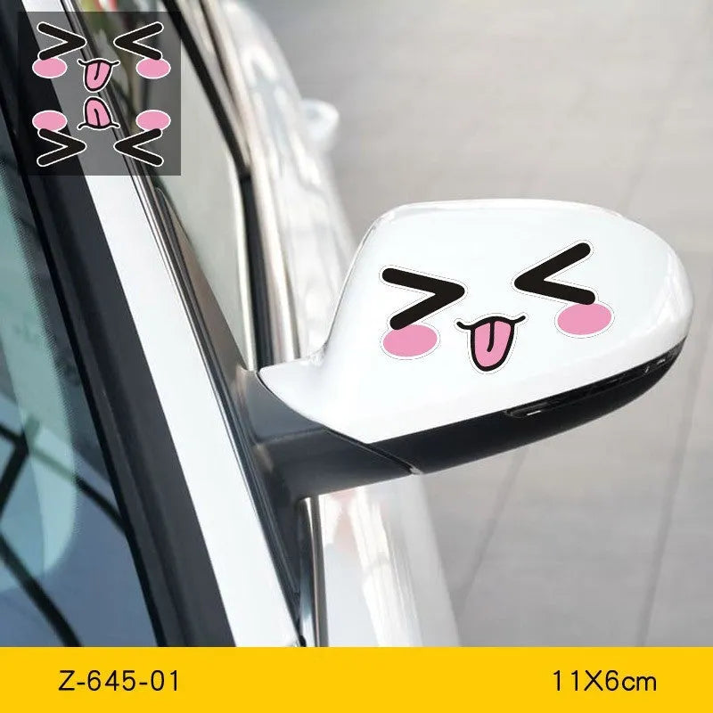 Pair of reflective cartoon eye car stickers on a vehicle rearview mirror.