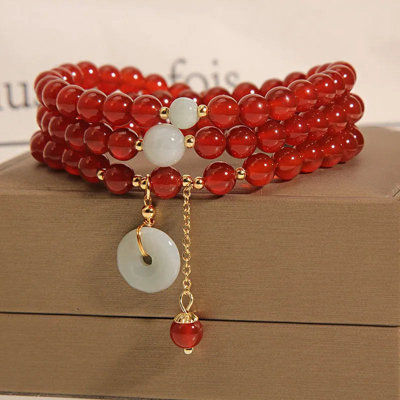 Red agate multi-layer bracelet with adjustable closure showing natural stone texture