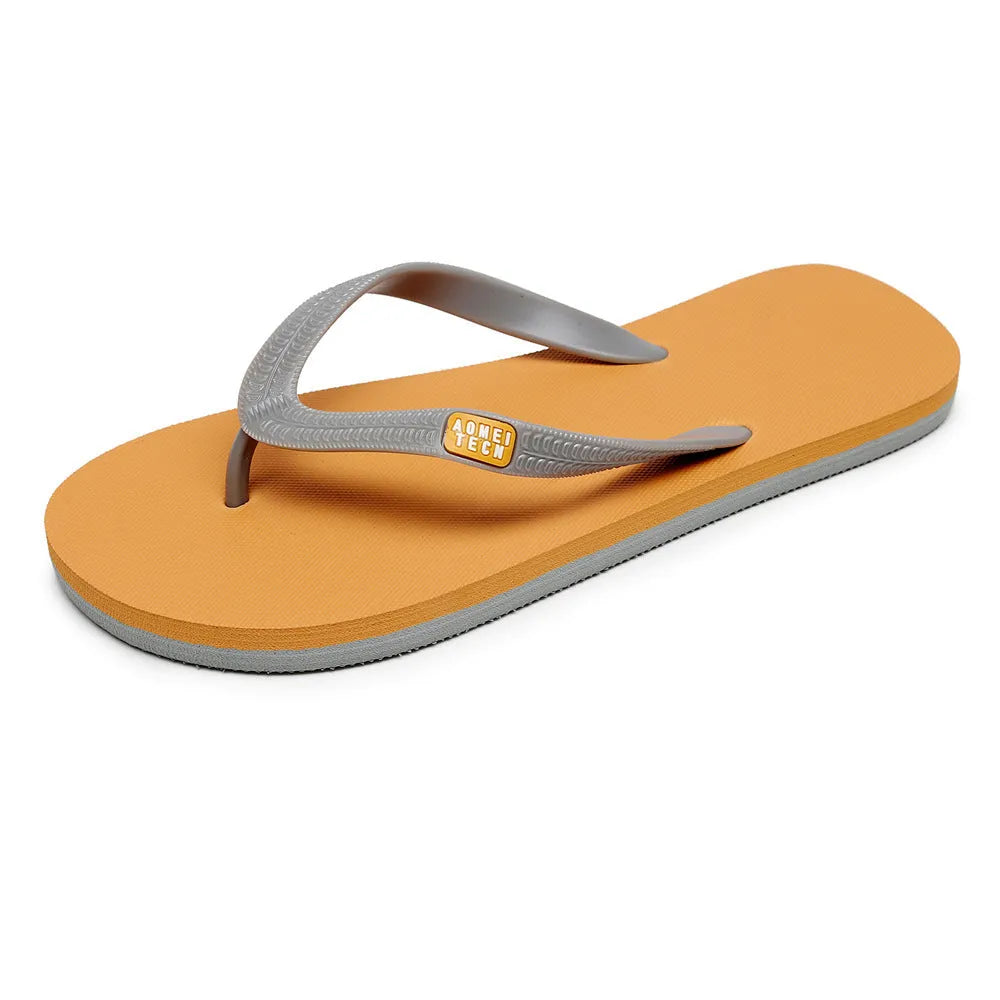 Men's black flip-flops with a textured rubber sole and EVA foam upper on a sandy beach.