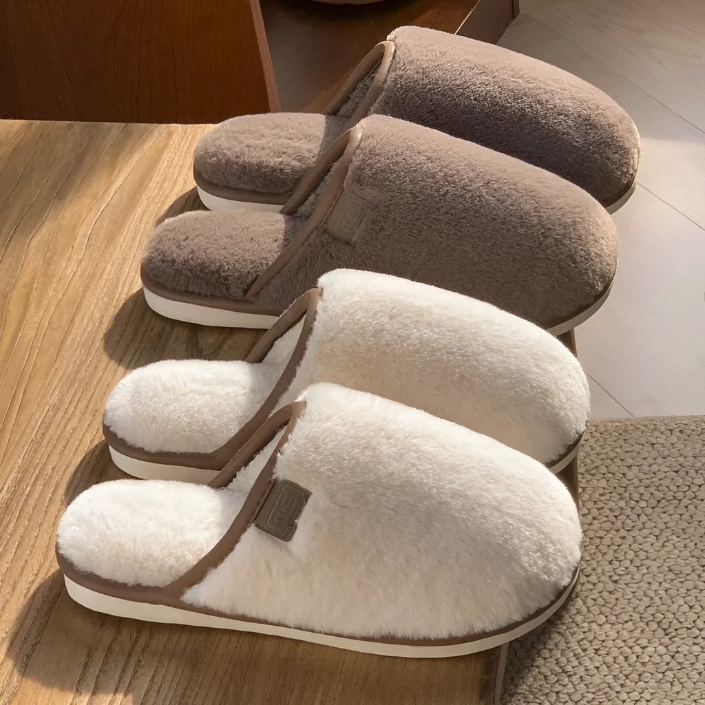 Solid colour winter plush slippers with non-slip PVC soles on a wooden floor