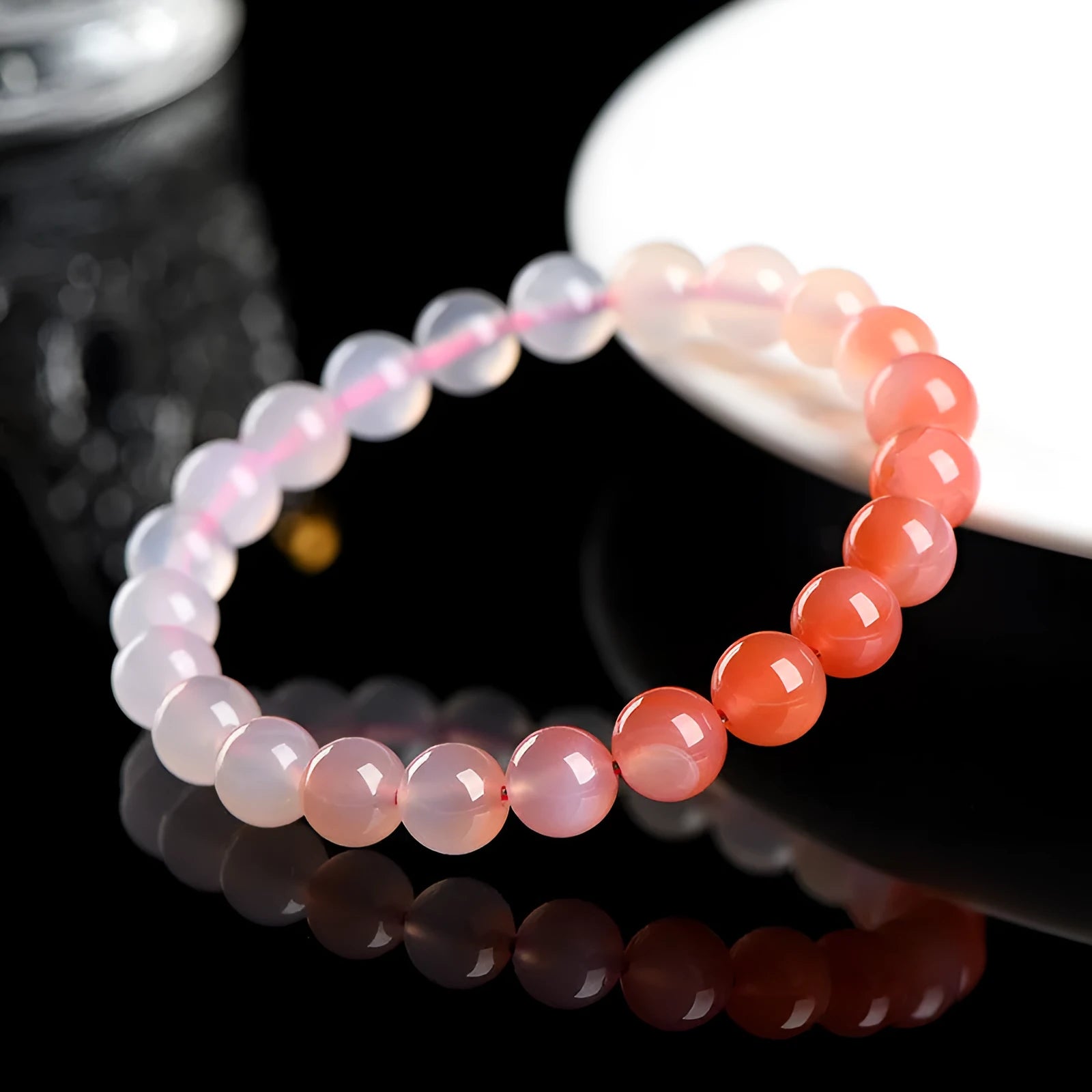 Natural gradient Yanyuan agate bracelet with geometric beads on a wrist, showing colour transition.