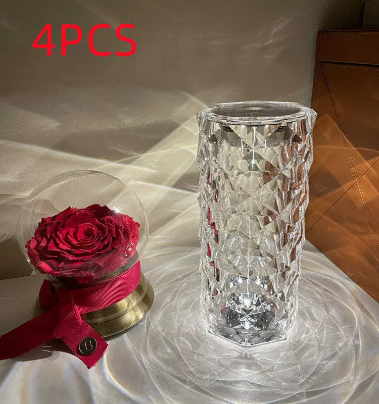 Modern acrylic rose LED table lamp with diamond base and touch control on wooden surface