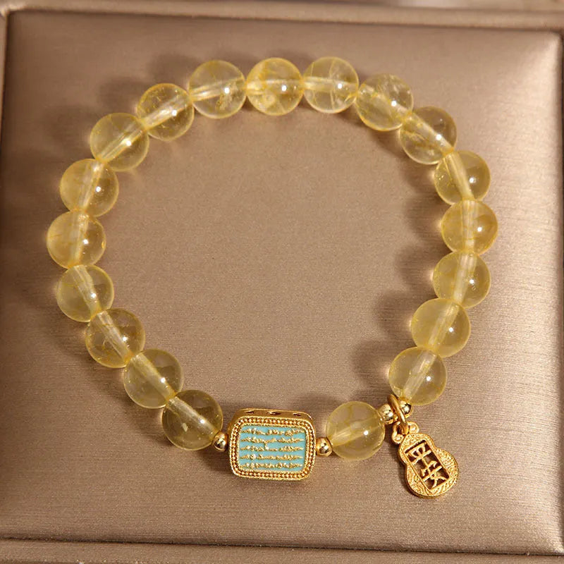 Women's yellow citrine crystal bracelet with rhinestone decorations on wrist