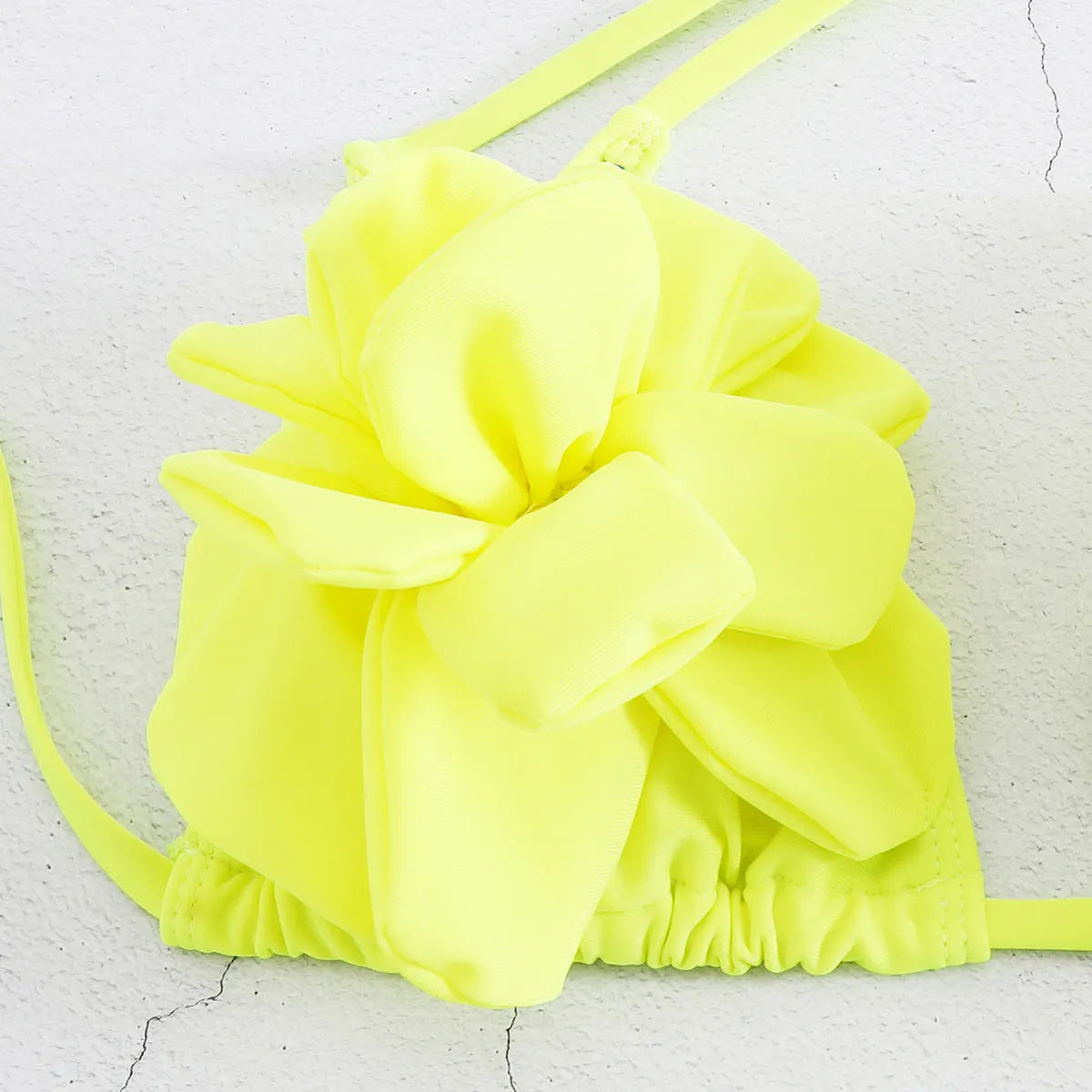 Women's low waist bikini swimsuit with 3D flower design in solid colour