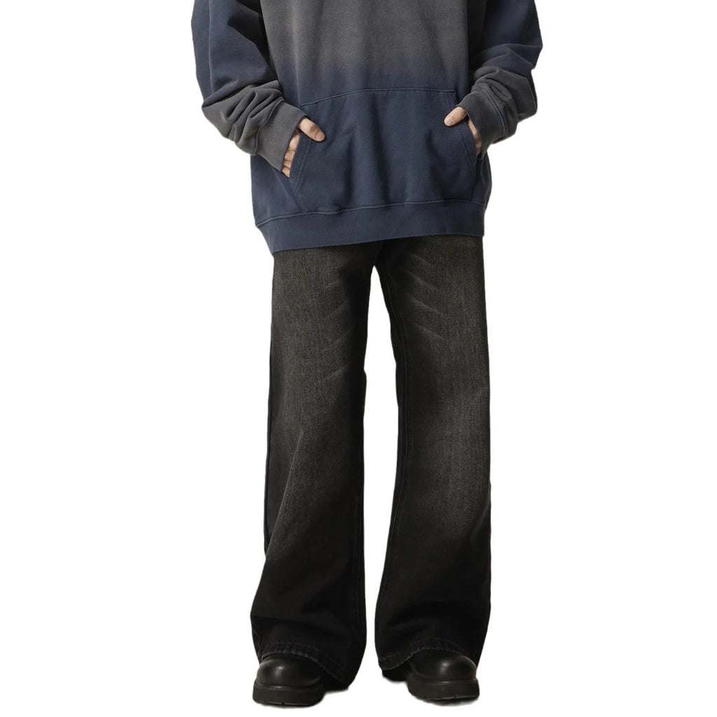 Black loose straight retro jeans with zipper fly closure on plain background