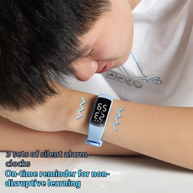 Waterproof vibration alarm watch with LED display and coloured silicone strap on a wrist.