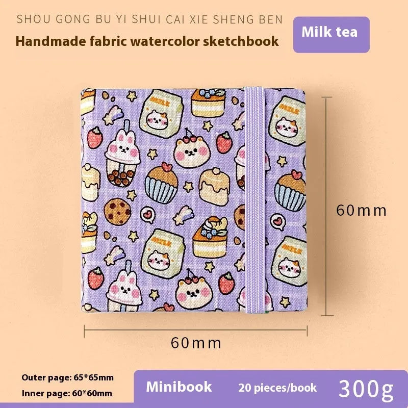 Feiluniao handmade fabric watercolour notebook with illustrated cover, open to show blank paper pages.