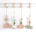 Beech wood baby rattle with animal pendants in orange, 28cm length, on white background