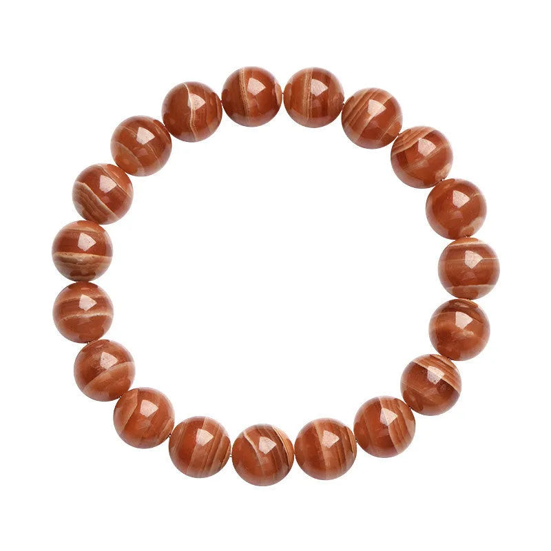 Natural old mine rhodochrosite round bead bracelet with Ruyi detail on a wrist.