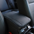 Black embossed PU leather car armrest box cushion mat measuring 32 by 19 centimetres.