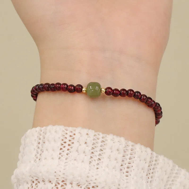 Chinese style gourd bracelet with imitation garnet stones and cultural motifs including Fu character design