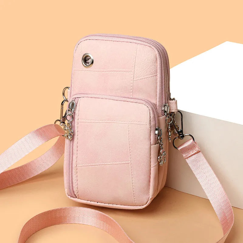 Square vertical mini mobile phone bag in PU leather, shown in water blue colour with a front sandwich pocket.