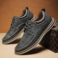 Men's black genuine leather casual lace-up shoes with round toe and rubber sole on a white background.