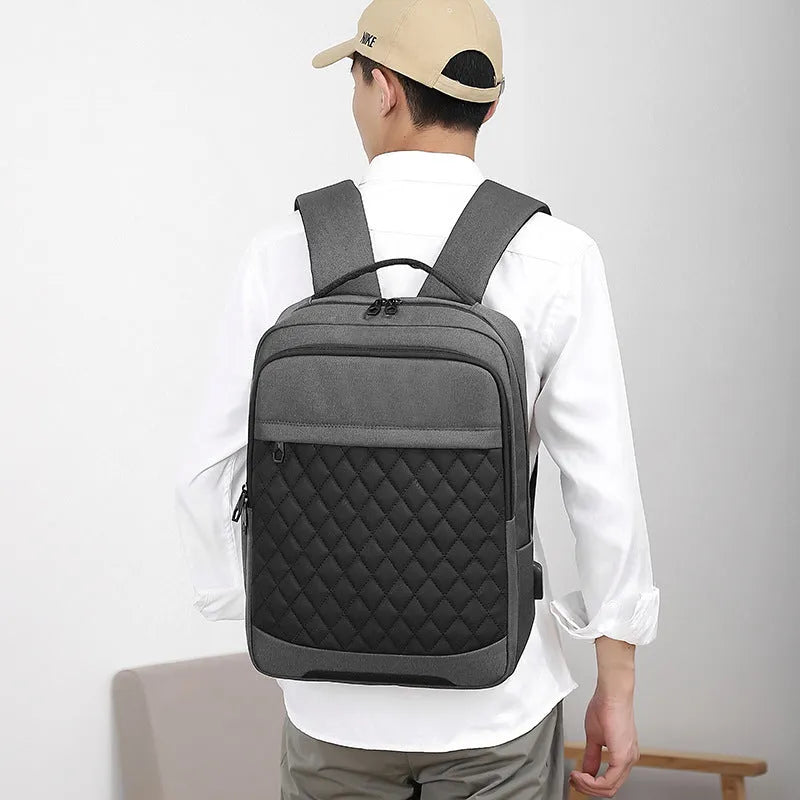 Men's black Oxford cloth travel backpack with curved shoulder straps and diamond mesh back panel