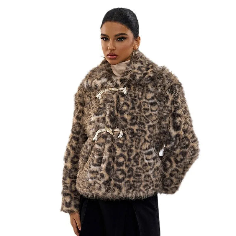 Women's leopard print coat with buckle lapel fastening on a hanger
