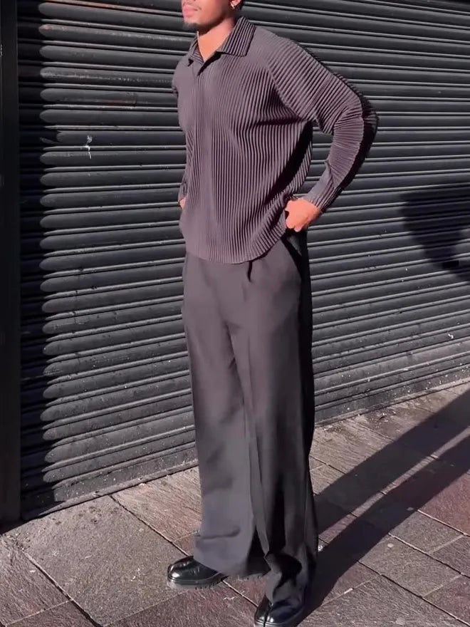 Men's black long-sleeved casual top with pleated detail, made from polyester fabric.