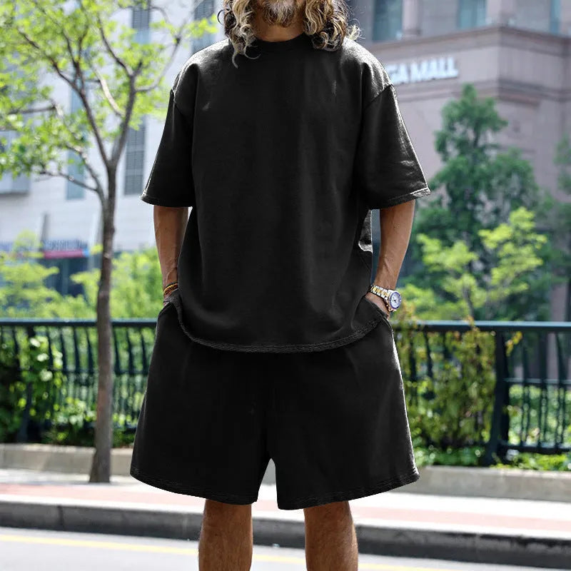 Men's casual sports suit set with grey round neck T-shirt and drawstring shorts on model