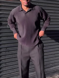 Men's black long-sleeved casual top with pleated detail, made from polyester fabric.