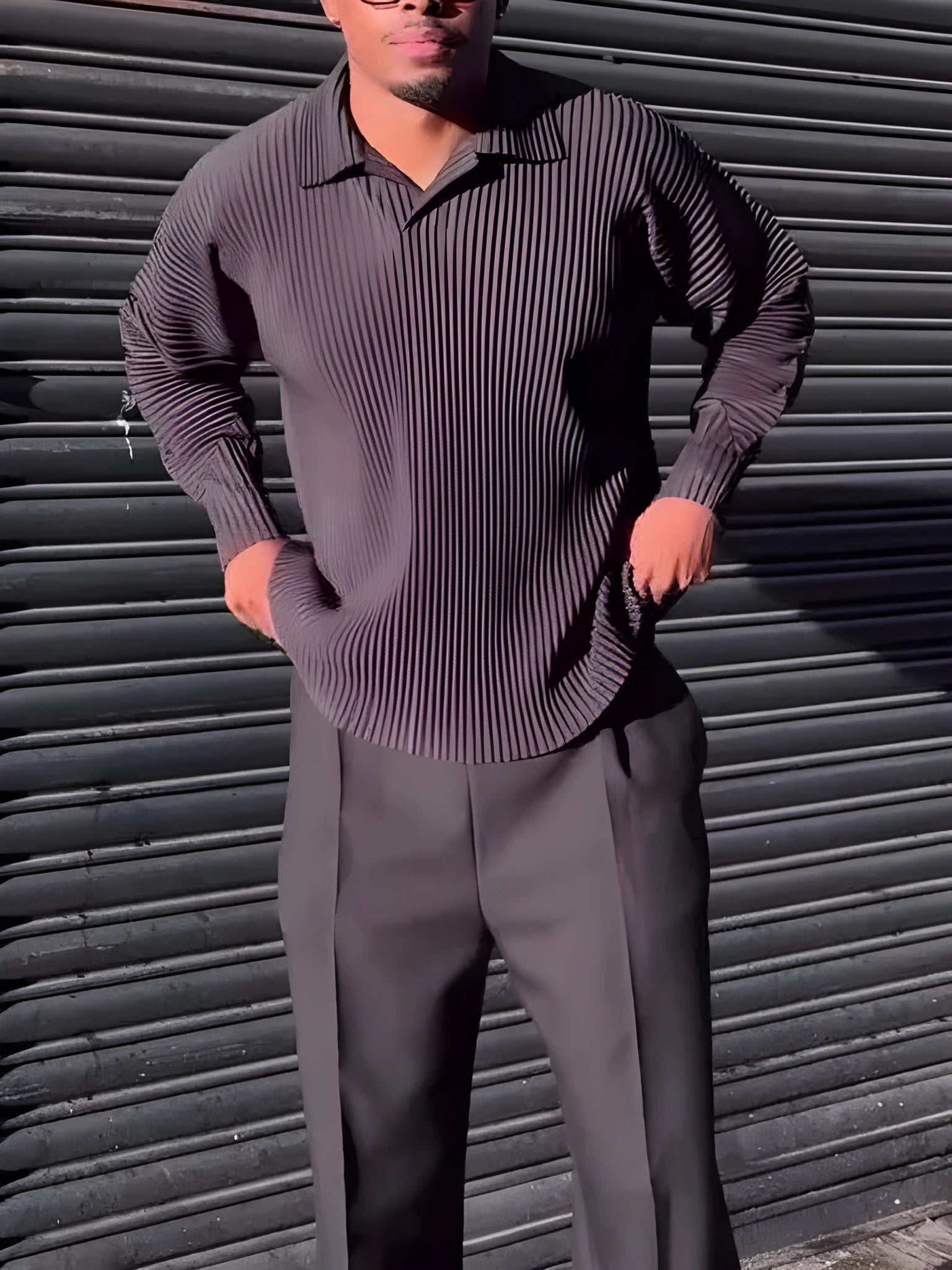 Men's black long-sleeved casual top with pleated detail, made from polyester fabric.