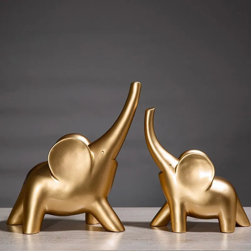 Modern resin elephant ornament in rose gold colour with raised trunk on display surface
