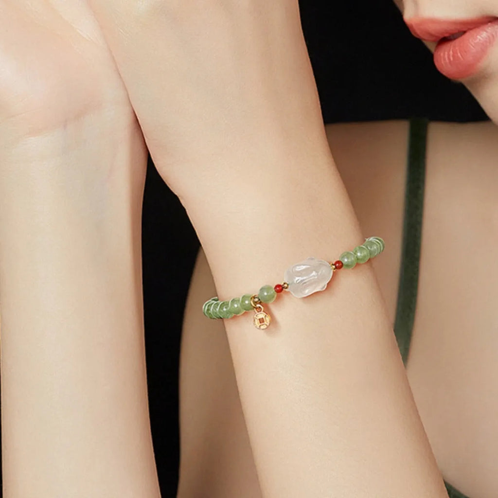 Handmade women's Hetian Jade Rabbit bracelet with glass rabbit charms in a gift box.