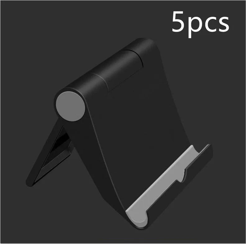Black PE folding stand holding a smartphone at an angle on a wooden table.