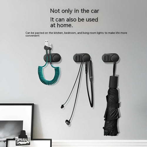 Dark green ABS silicone car cable hook with adhesive backing for organising data cables on a dashboard.