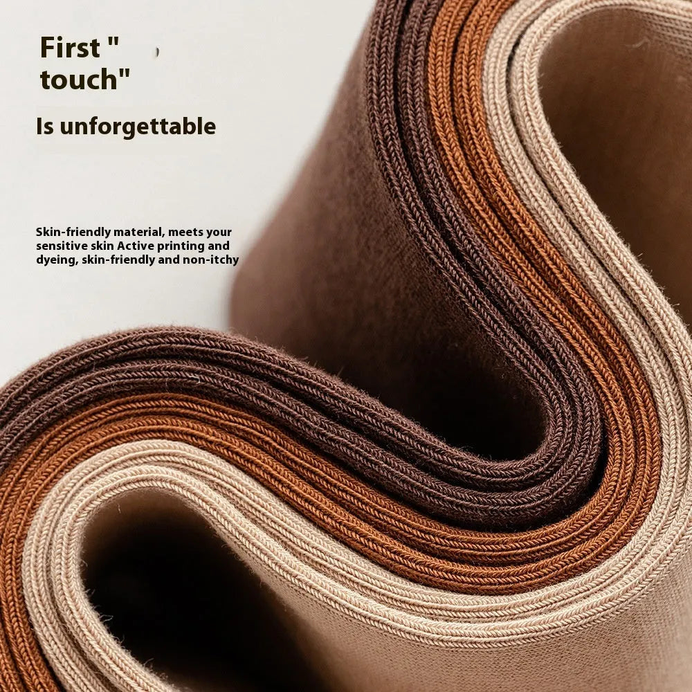 Five pairs of men's solid colour mid-calf socks made from combed cotton, shown in assorted shades.