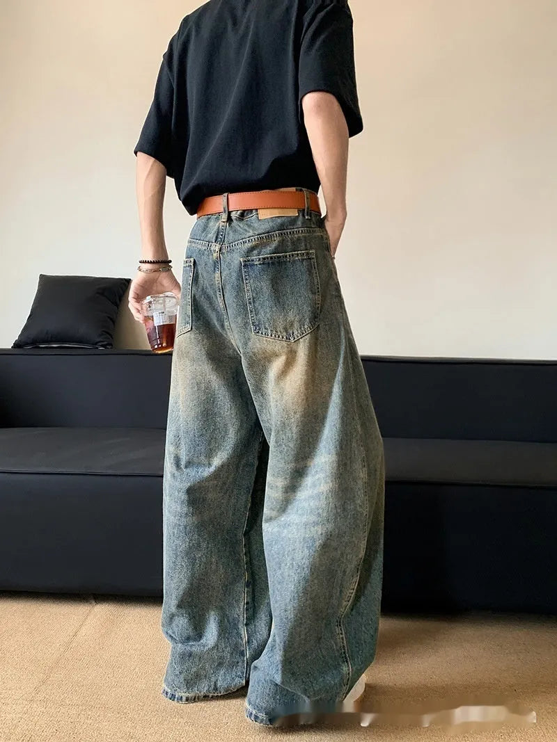 Men's retro blue distressed denim jeans with machete detailing and wide-leg fit