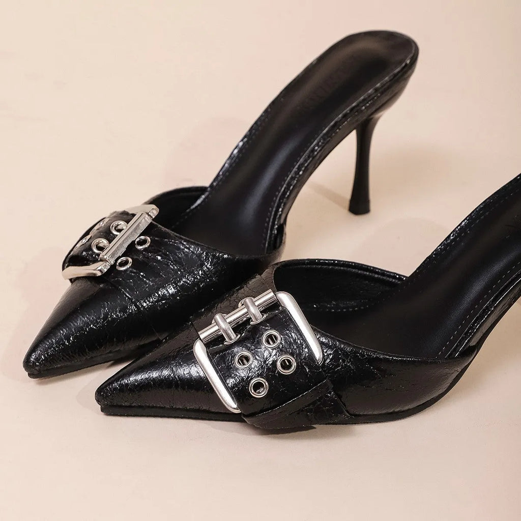 Black women's pointed toe high heels with a strap and buckle closure.