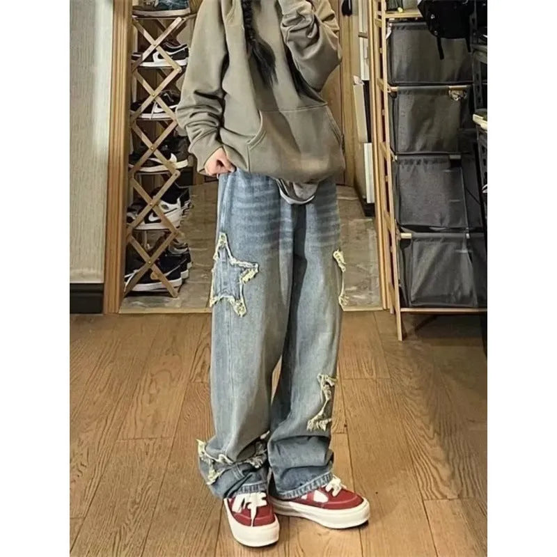 Blue high-waisted women's wide-leg denim jeans on a model, showing the straight-leg cut.