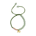 Hand woven red rope bracelet with floral decorative elements in national style design