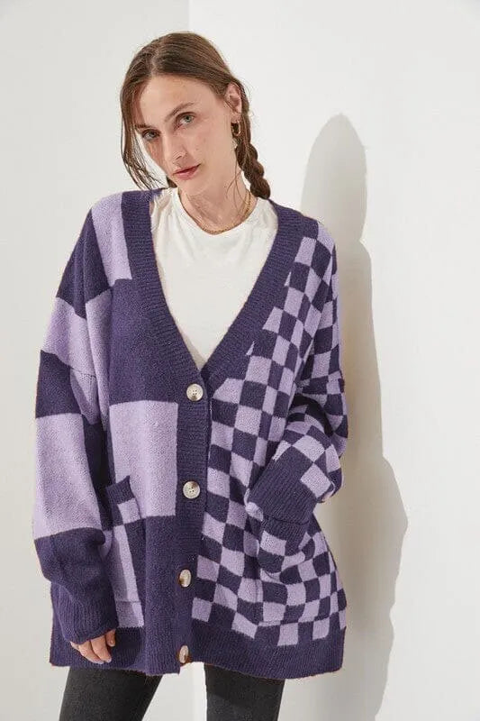 Loose fit knitwear cardigan with checks print in a selection of colours on a hanger.