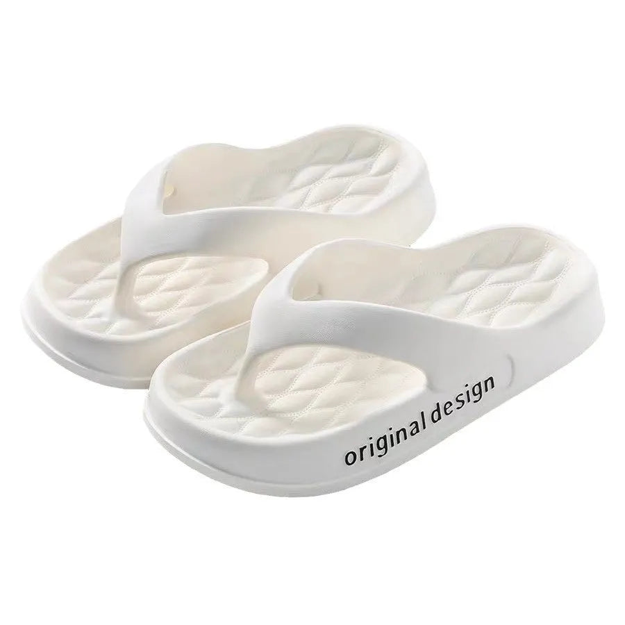 Men's black EVA flip flops with injection-moulded sole on a sandy beach.