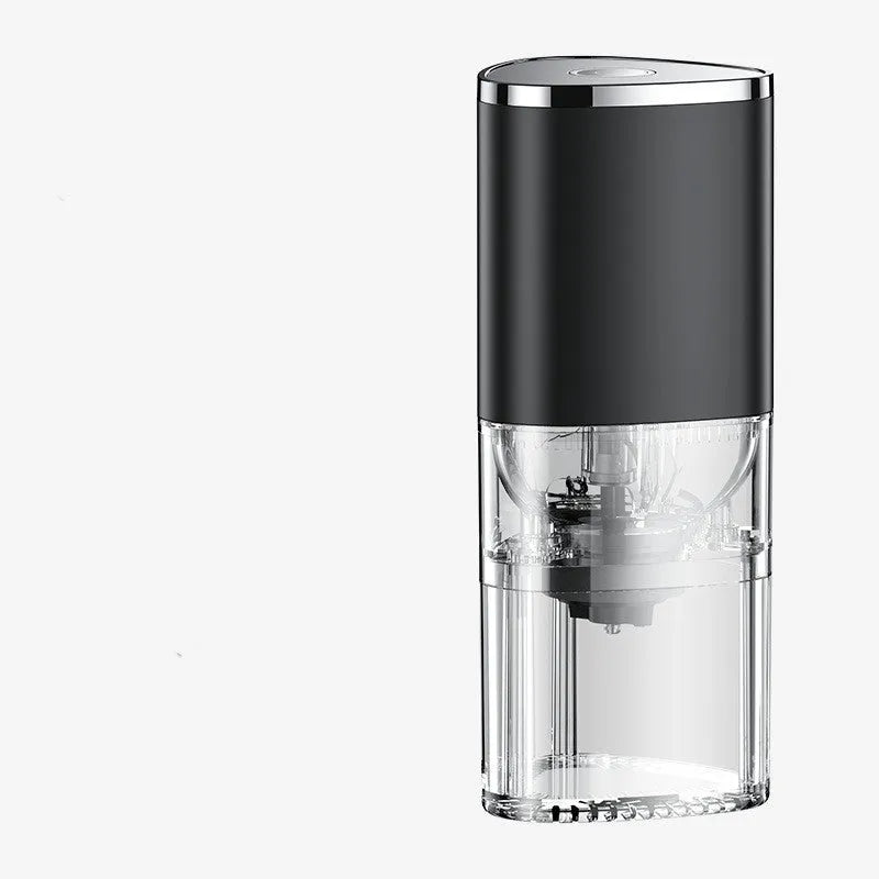 White portable electric coffee grinder with ceramic burr and USB charging cable on a kitchen counter.