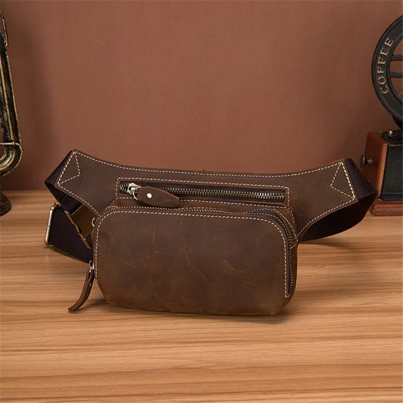 Brown genuine cowhide men's sports waist bag with pull closure showing internal mobile phone pocket