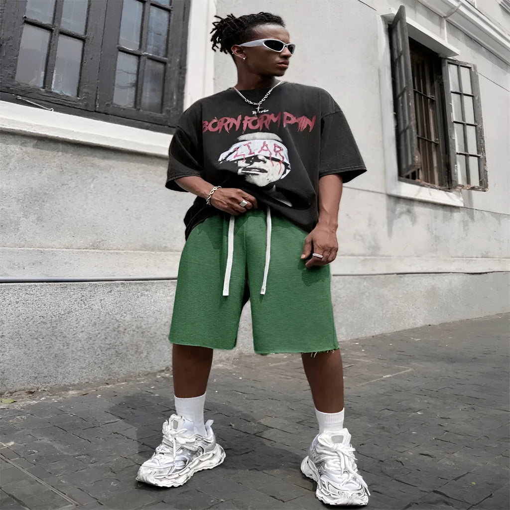 Men's straight leg polyester trousers in black, shown in a streetwear style pose.