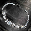 Women's silver-plated geometric zircon bracelet in white gold tone on wrist, close-up view