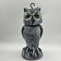 Artificial owl bird deterrent ornament with shaking head design in outdoor garden setting