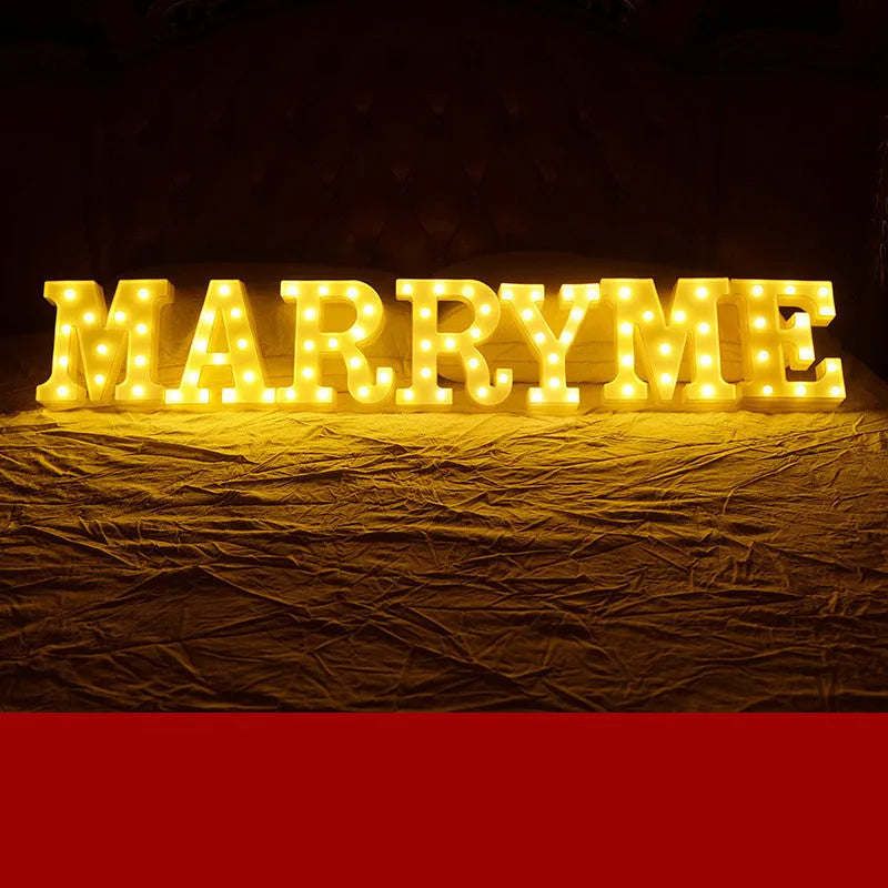 Plastic LED letter light decoration spelling a message, 22cm in height.