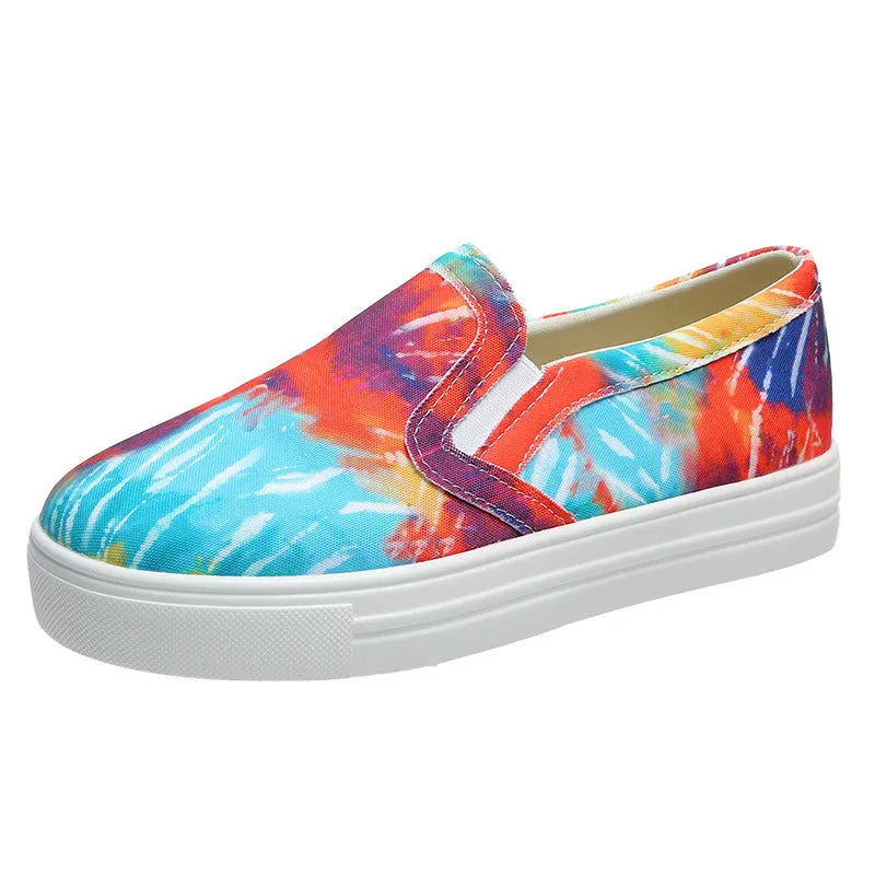 Women's low-top canvas trainers in blue, green, black and colourful designs on a flat rubber sole.