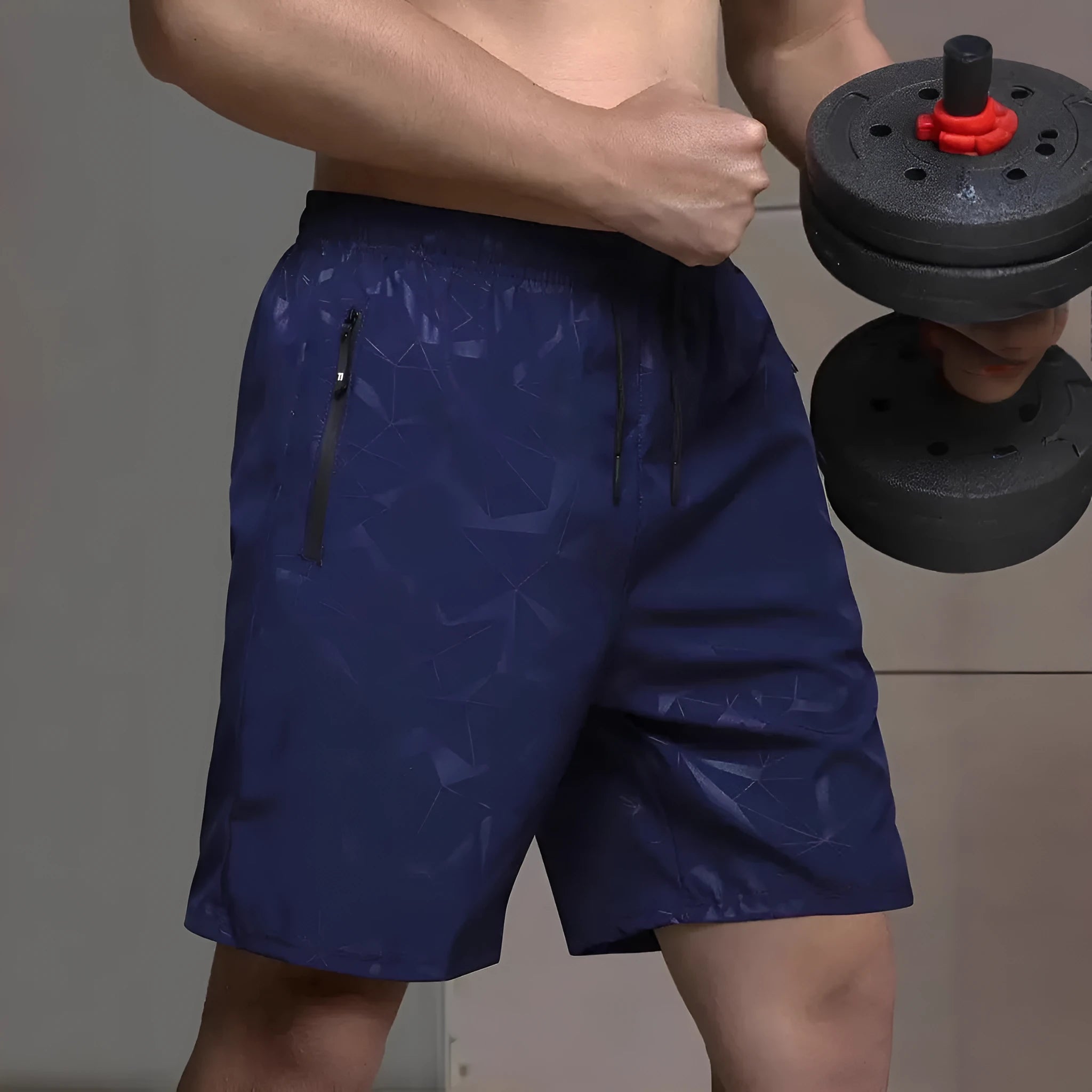 Man wearing loose fit black polyester sports shorts with elastic waistband