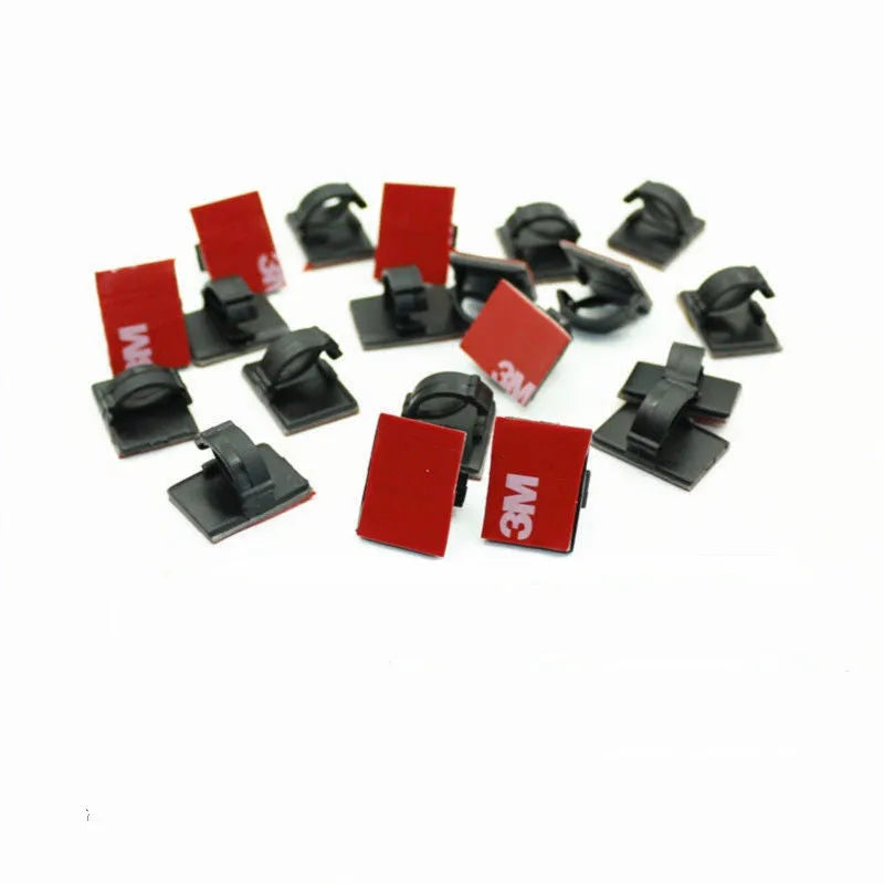 Black and white self-adhesive plastic wire buckles for securing cables, shown in assorted pack sizes.