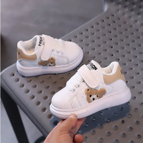 Children's black cartoon bear casual sports shoes with artificial leather upper and rubber sole.